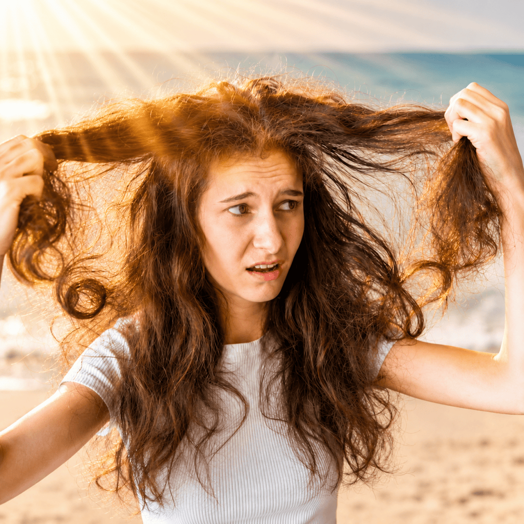 Woman with dry, tangled hair after prolonged sun exposure at the beach.